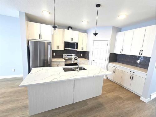 1197 Iron Ridge Avenue, Crossfield, AB - Indoor Photo Showing Kitchen With Double Sink With Upgraded Kitchen