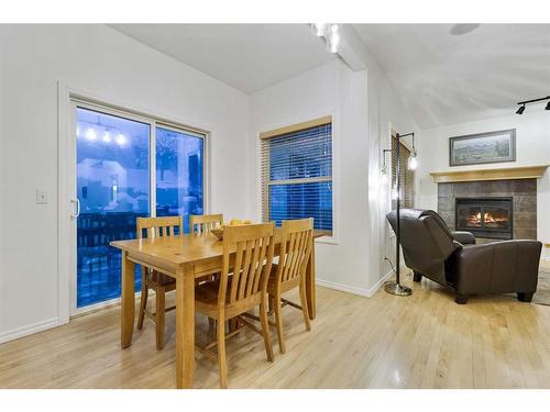 206 Discovery Ridge Way Sw, Calgary, AB - Indoor Photo Showing Dining Room With Fireplace