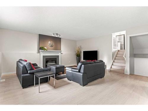 148 Woodbend Way, Okotoks, AB - Indoor Photo Showing Living Room With Fireplace