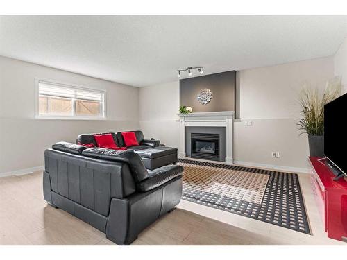 148 Woodbend Way, Okotoks, AB - Indoor Photo Showing Living Room With Fireplace