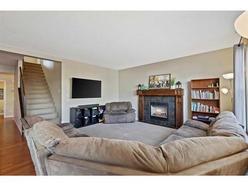 83 Copperstone Boulevard Se, Calgary, AB - Indoor Photo Showing Living Room With Fireplace