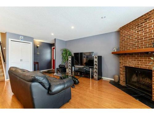 8203 Ranchview Drive Nw, Calgary, AB - Indoor Photo Showing Living Room With Fireplace