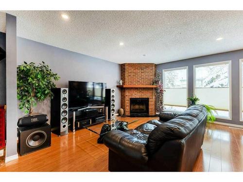 8203 Ranchview Drive Nw, Calgary, AB - Indoor Photo Showing Living Room With Fireplace