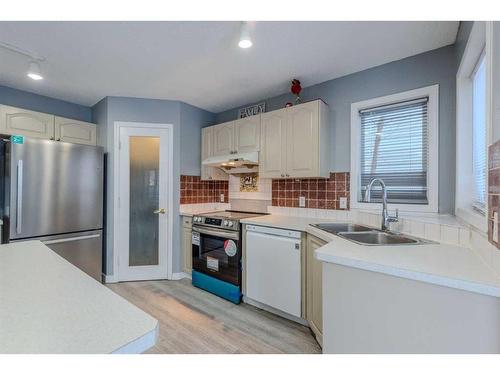 84 Douglas Glen Crescent Se, Calgary, AB - Indoor Photo Showing Kitchen With Double Sink