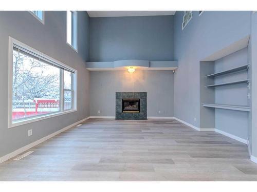 84 Douglas Glen Crescent Se, Calgary, AB - Indoor Photo Showing Living Room With Fireplace