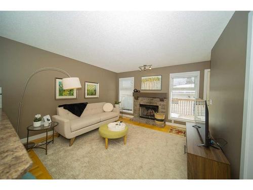 251 Coachway Road Sw, Calgary, AB - Indoor Photo Showing Living Room With Fireplace