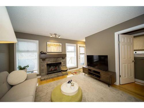 251 Coachway Road Sw, Calgary, AB - Indoor Photo Showing Living Room With Fireplace