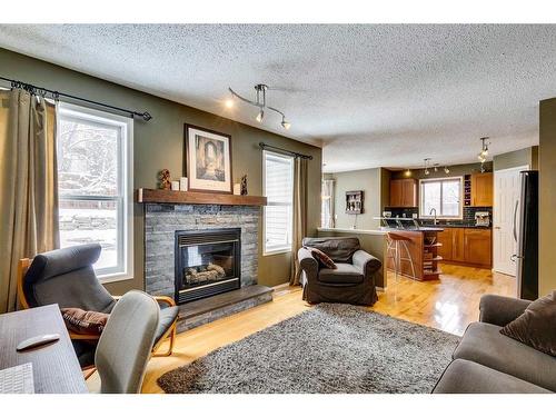 32 Hidden Creek Park Nw, Calgary, AB - Indoor Photo Showing Living Room With Fireplace