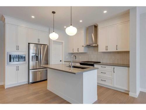 46 Fireside Point, Cochrane, AB - Indoor Photo Showing Kitchen With Double Sink With Upgraded Kitchen