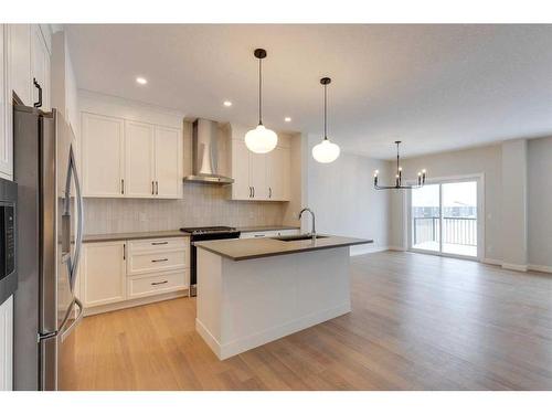 46 Fireside Point, Cochrane, AB - Indoor Photo Showing Kitchen With Upgraded Kitchen