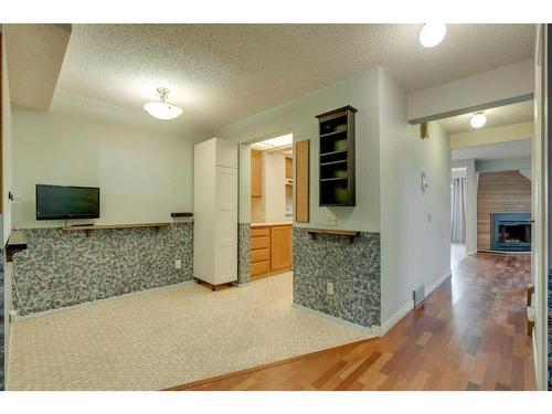 7 Stradwick Place Sw, Calgary, AB - Indoor Photo Showing Other Room With Fireplace