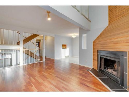 7 Stradwick Place Sw, Calgary, AB - Indoor Photo Showing Living Room With Fireplace