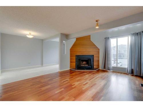 7 Stradwick Place Sw, Calgary, AB - Indoor Photo Showing Living Room With Fireplace