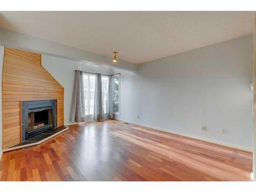 7 Stradwick Place Sw, Calgary, AB - Indoor Photo Showing Living Room With Fireplace