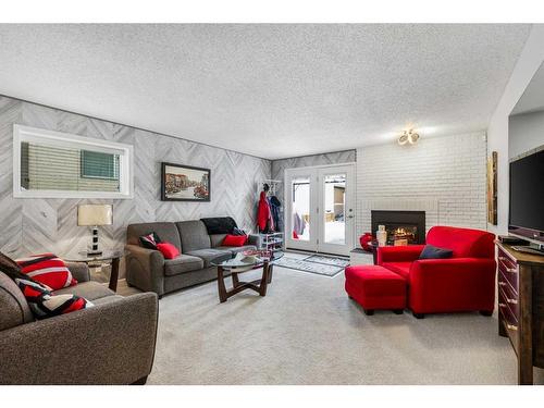 131 Shawcliffe Circle Sw, Calgary, AB - Indoor Photo Showing Living Room With Fireplace