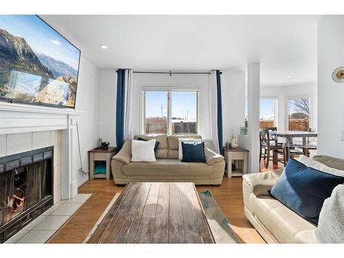 173 Coral Sands Place Ne, Calgary, AB - Indoor Photo Showing Living Room With Fireplace