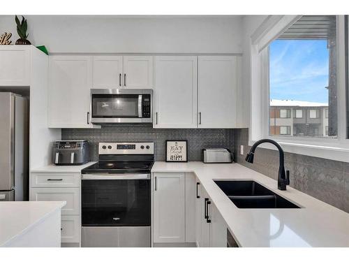 302 Corner Glen Circle Ne, Calgary, AB - Indoor Photo Showing Kitchen With Stainless Steel Kitchen With Double Sink