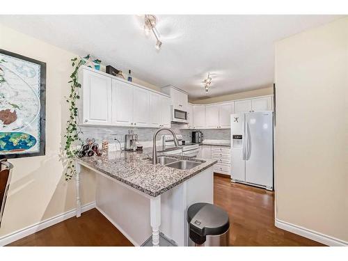 19 Mt Mckenzie Way Se, Calgary, AB - Indoor Photo Showing Kitchen With Double Sink