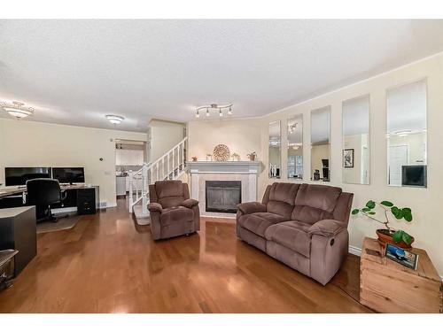 19 Mt Mckenzie Way Se, Calgary, AB - Indoor Photo Showing Living Room With Fireplace