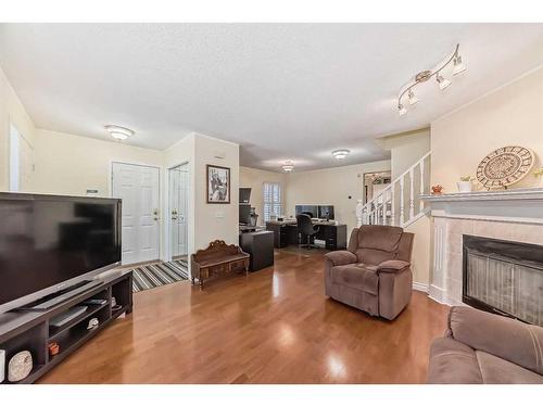 19 Mt Mckenzie Way Se, Calgary, AB - Indoor Photo Showing Living Room With Fireplace