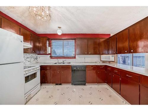 255 Rundleridge Drive Ne, Calgary, AB - Indoor Photo Showing Kitchen With Double Sink