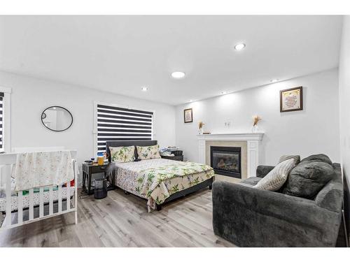 2046 Luxstone Boulevard, Airdrie, AB - Indoor Photo Showing Bedroom With Fireplace