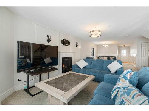 43 Prominence Path Sw, Calgary, AB - Indoor Photo Showing Living Room With Fireplace