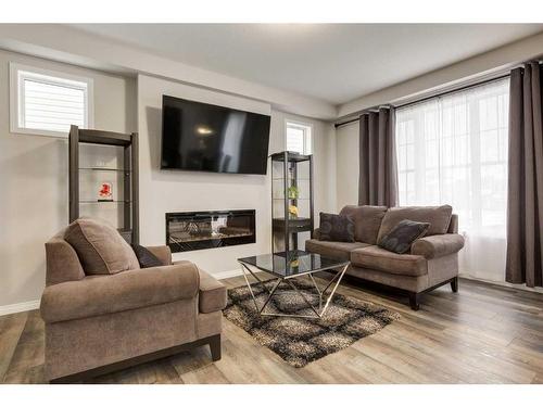 24 Osborne Link Sw, Airdrie, AB - Indoor Photo Showing Living Room With Fireplace