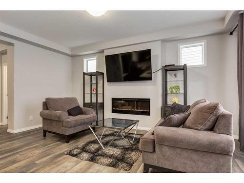 24 Osborne Link Sw, Airdrie, AB - Indoor Photo Showing Living Room With Fireplace