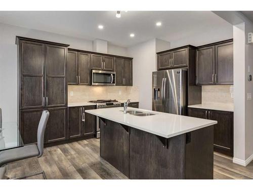 24 Osborne Link Sw, Airdrie, AB - Indoor Photo Showing Kitchen With Stainless Steel Kitchen With Double Sink With Upgraded Kitchen