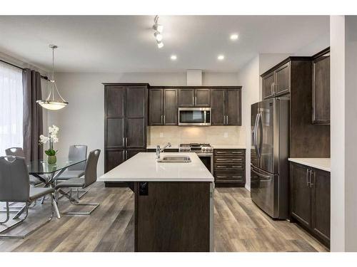 24 Osborne Link Sw, Airdrie, AB - Indoor Photo Showing Kitchen With Stainless Steel Kitchen With Double Sink With Upgraded Kitchen