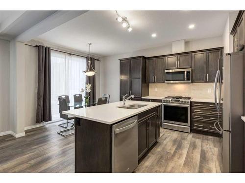 24 Osborne Link Sw, Airdrie, AB - Indoor Photo Showing Kitchen With Stainless Steel Kitchen With Double Sink With Upgraded Kitchen