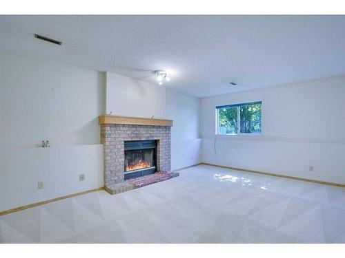 9029 21 Street Se, Calgary, AB - Indoor Photo Showing Living Room With Fireplace