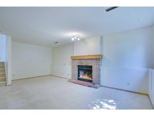 9029 21 Street Se, Calgary, AB - Indoor Photo Showing Living Room With Fireplace