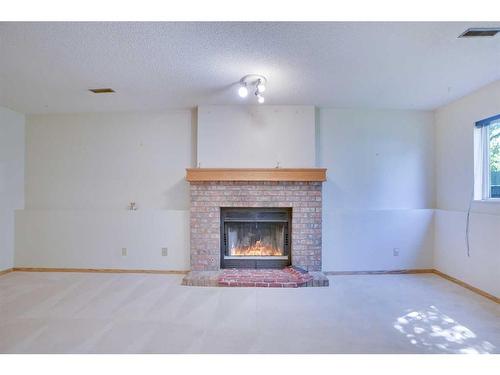 9029 21 Street Se, Calgary, AB - Indoor Photo Showing Living Room With Fireplace