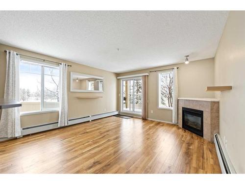 2107-70 Panamount Drive Nw, Calgary, AB - Indoor Photo Showing Living Room With Fireplace