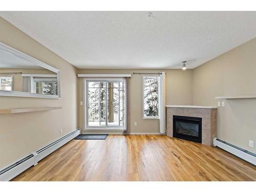 2107-70 Panamount Drive Nw, Calgary, AB - Indoor Photo Showing Living Room With Fireplace