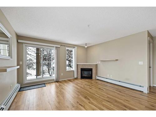 2107-70 Panamount Drive Nw, Calgary, AB - Indoor Photo Showing Living Room With Fireplace