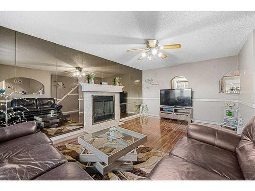 81 Castleglen Road Ne, Calgary, AB - Indoor Photo Showing Living Room With Fireplace