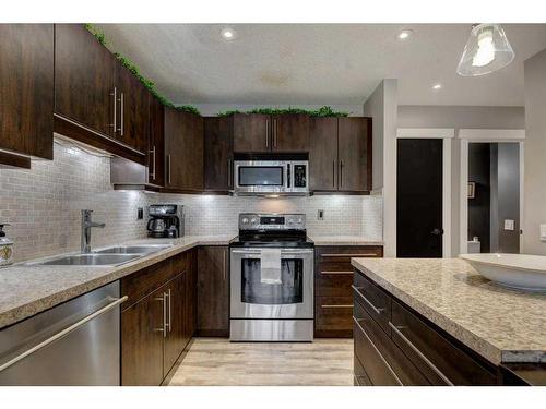 7-10001 Brookpark Boulevard Sw, Calgary, AB - Indoor Photo Showing Kitchen With Stainless Steel Kitchen With Double Sink