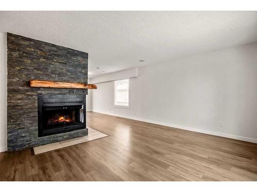 15 Alcock Close, Okotoks, AB - Indoor Photo Showing Living Room With Fireplace