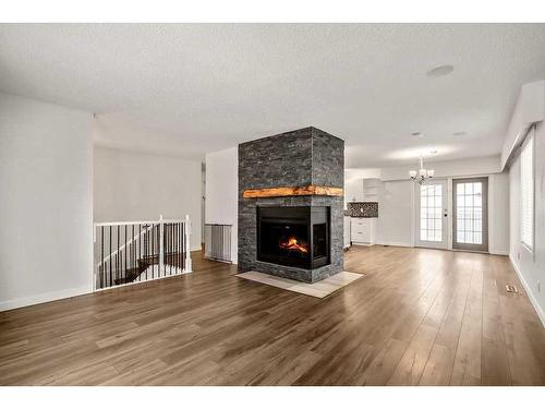 15 Alcock Close, Okotoks, AB - Indoor Photo Showing Living Room With Fireplace