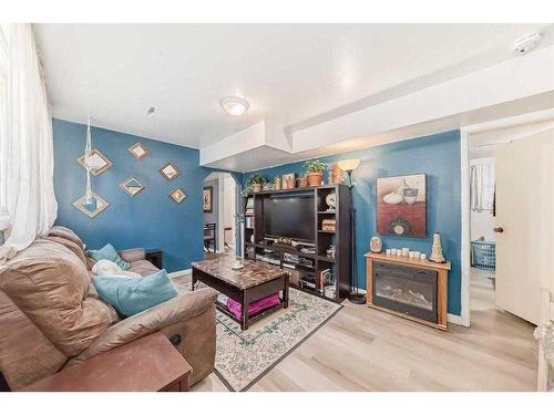 3720 Centre A Street Ne, Calgary, AB - Indoor Photo Showing Living Room With Fireplace