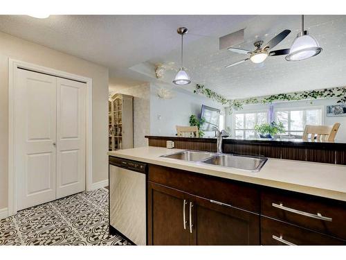 224-15 Sunset Square, Cochrane, AB - Indoor Photo Showing Kitchen With Double Sink