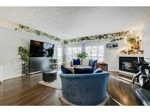 224-15 Sunset Square, Cochrane, AB - Indoor Photo Showing Living Room With Fireplace