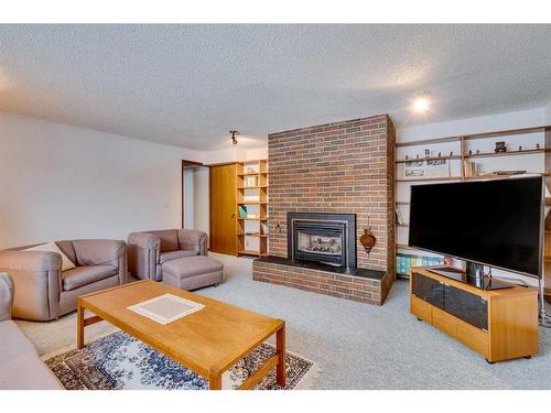 3410 Breton Close Nw, Calgary, AB - Indoor Photo Showing Living Room With Fireplace