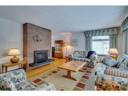 3410 Breton Close Nw, Calgary, AB - Indoor Photo Showing Living Room With Fireplace