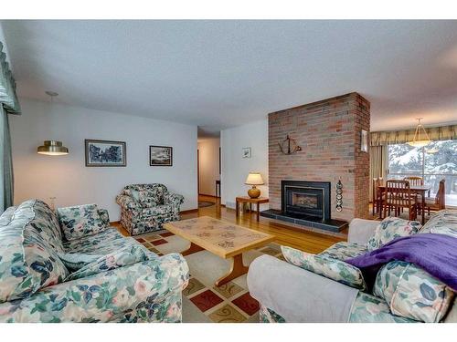 3410 Breton Close Nw, Calgary, AB - Indoor Photo Showing Living Room With Fireplace