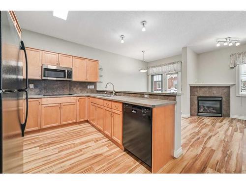 46 Tucker Circle, Okotoks, AB - Indoor Photo Showing Kitchen With Fireplace