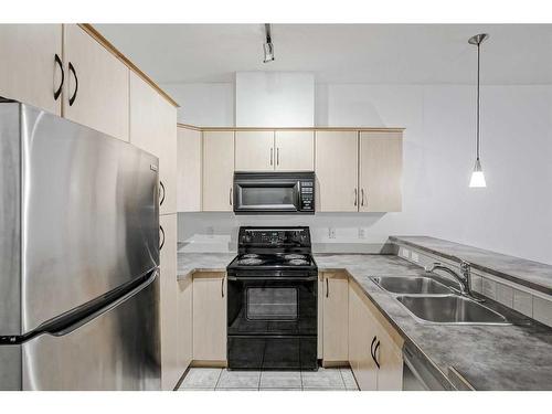 105-1408 17 Street Se, Calgary, AB - Indoor Photo Showing Kitchen With Double Sink